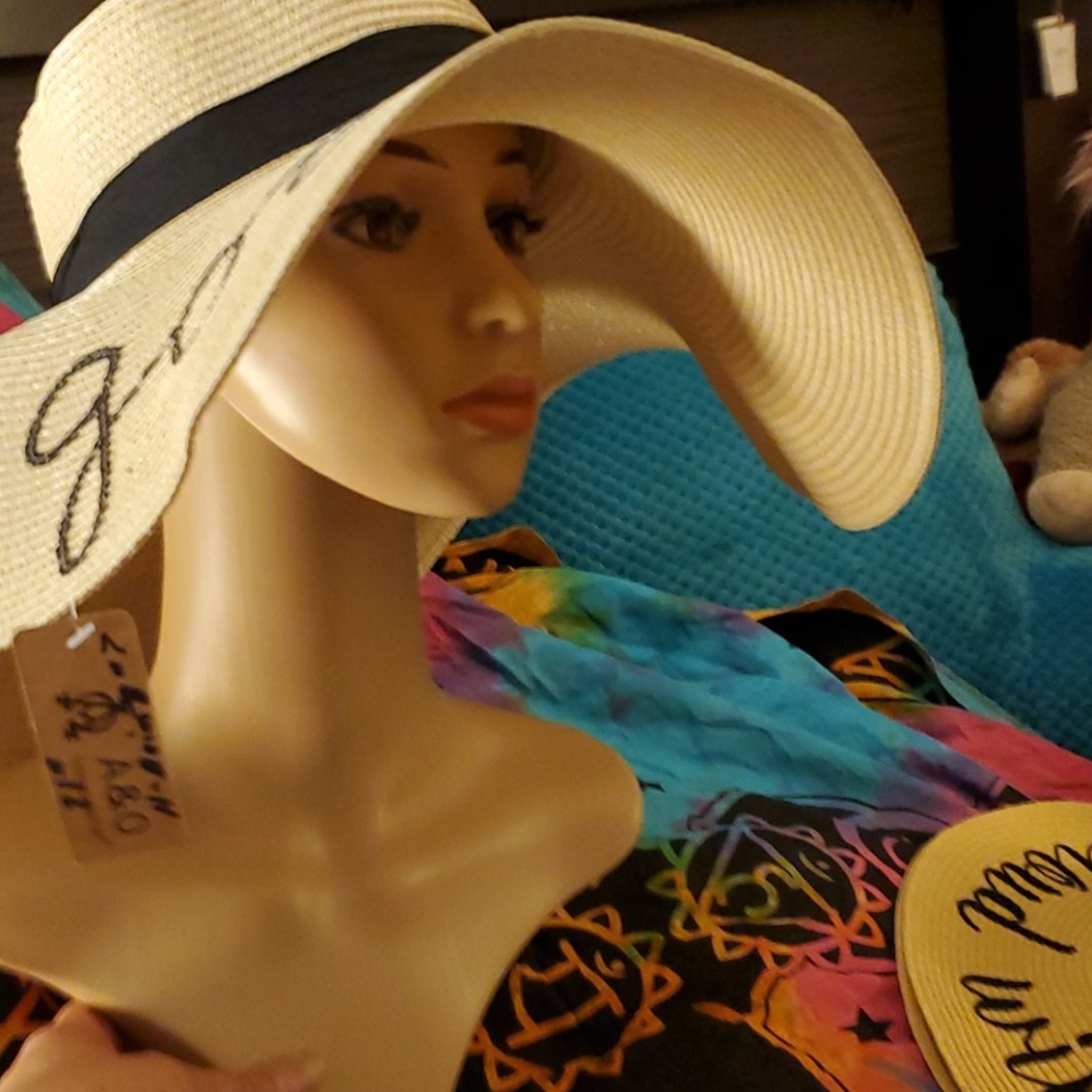 Huge floppy beach hat with" life is good" on top